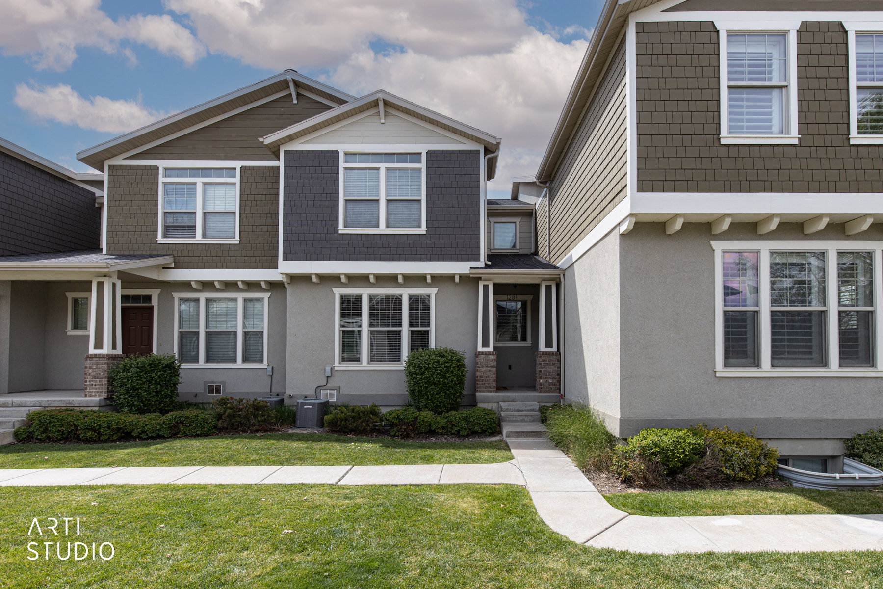 Craftsman inspired home with a front yard and stucco siding