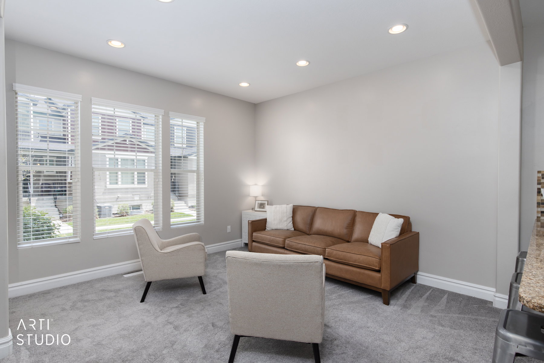 Living room featuring light colored carpet and recessed lighting