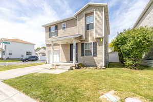 Traditional home with an attached garage and concrete driveway