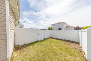 Fenced backyard with a gate