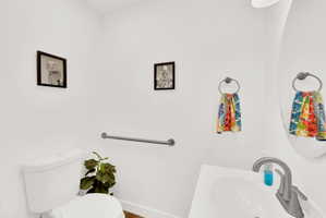 Half bathroom with toilet and a sink
