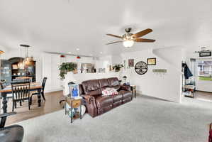 Living room featuring recessed lighting, a ceiling fan, and light carpet