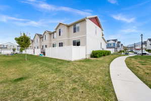 View of property exterior with a residential view and board and batten siding