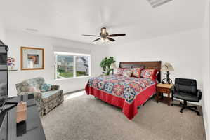 Carpeted bedroom with ceiling fan