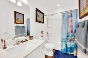 Full bath with vanity, shower / tub combo, dark wood finished floors, and recessed lighting