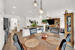 Dining area with light wood-style flooring, recessed lighting, and a ceiling fan