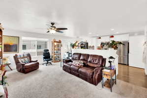 Living room featuring ceiling fan, recessed lighting, and light carpet
