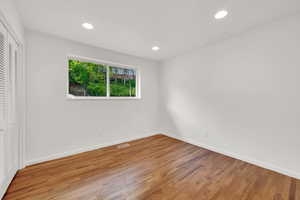 Unfurnished bedroom featuring light wood finished floors, recessed lighting, and a closet
