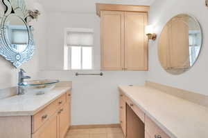 Bathroom featuring vanity and light tile patterned floors