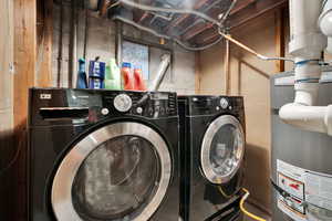 Laundry area featuring secured water heater and independent washer and dryer