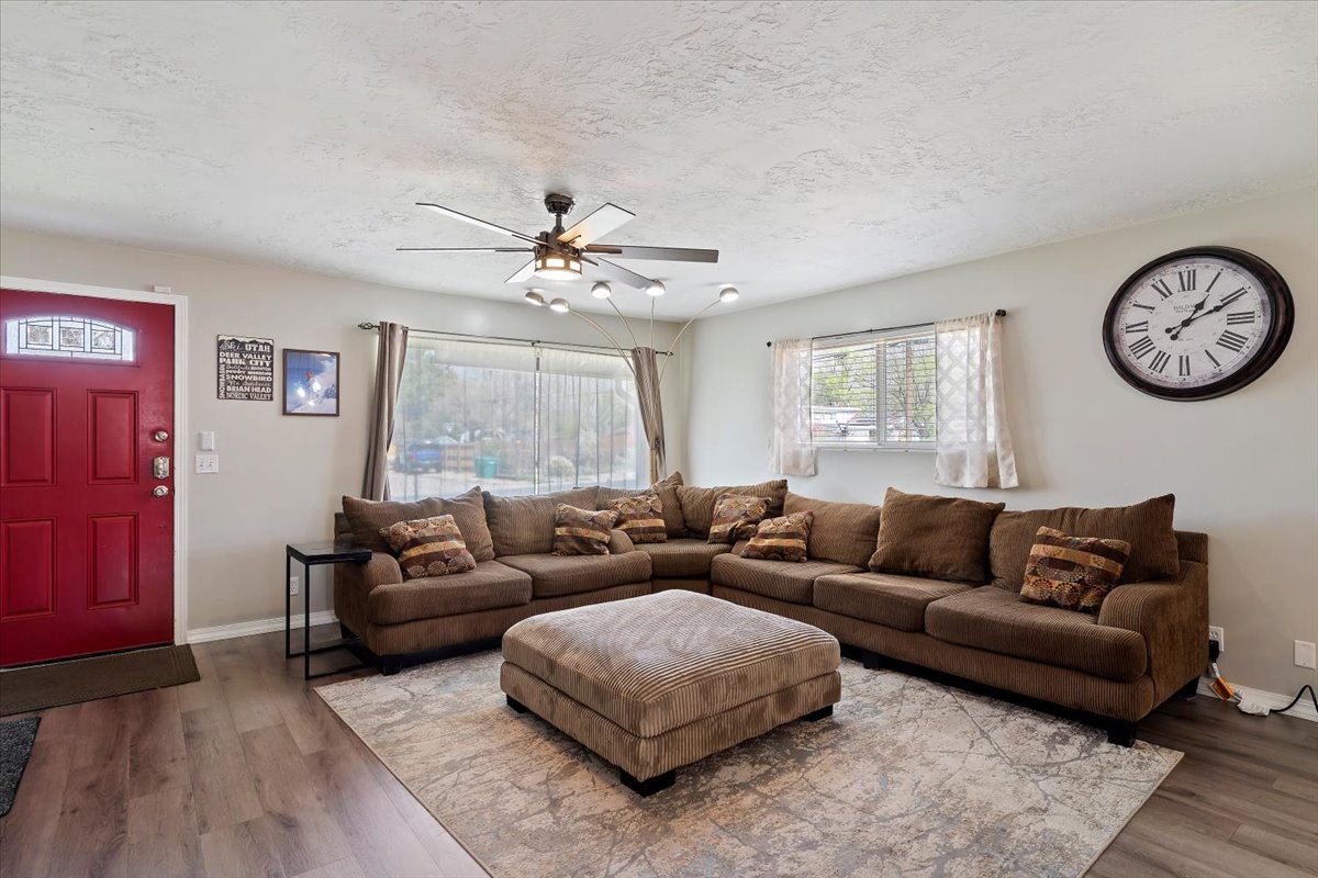 Living area with a ceiling fan, LVP floors, and a textured ceiling
