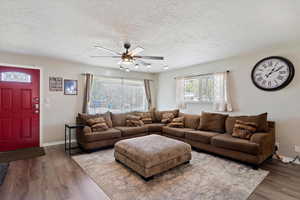 Living area with a ceiling fan, LVP floors, and a textured ceiling