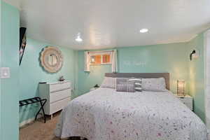 Bedroom with light carpet and recessed lighting