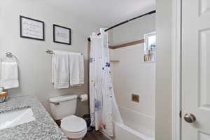 Bathroom featuring shower / bathtub combination with curtain and vanity