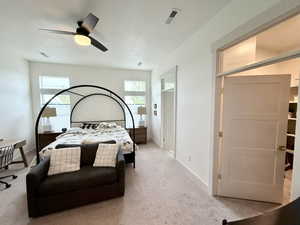 Master Bedroom featuring a spacious walk in closet, ensuite bath, ceiling fan