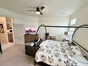 Master Bedroom featuring a spacious walk in closet, ensuite bath, ceiling fan