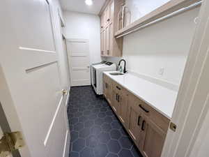 Walkthrough laundry room with access to the rest of the wraparound hallway with access to guest bed, main bath, and master suite.