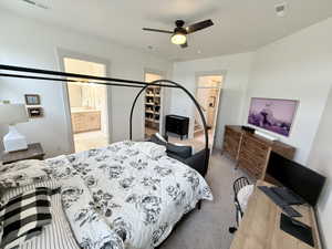 Master Bedroom featuring a spacious walk in closet, ensuite bath, ceiling fan
