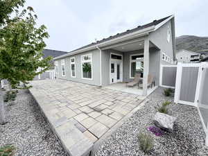 Rear view of property featuring a fenced backyard and patio area