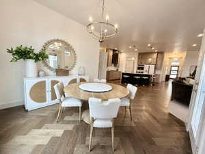 Dining area with suspended lighting and parquet flooring