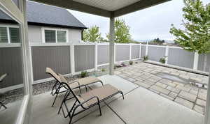 Fenced backyard featuring a covered patio