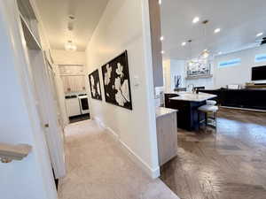 Wraparound hallway leading to bathroom, closet, guest bedroom and laundry room
