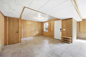 Entrance foyer featuring wooden walls