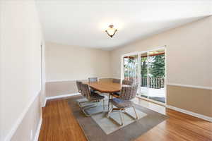 Dining space featuring light wood-style flooring and baseboards