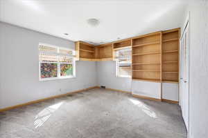 Unfurnished bedroom featuring light carpet and a closet