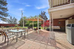 View of patio / terrace featuring an outdoor living / dining area and a pergola