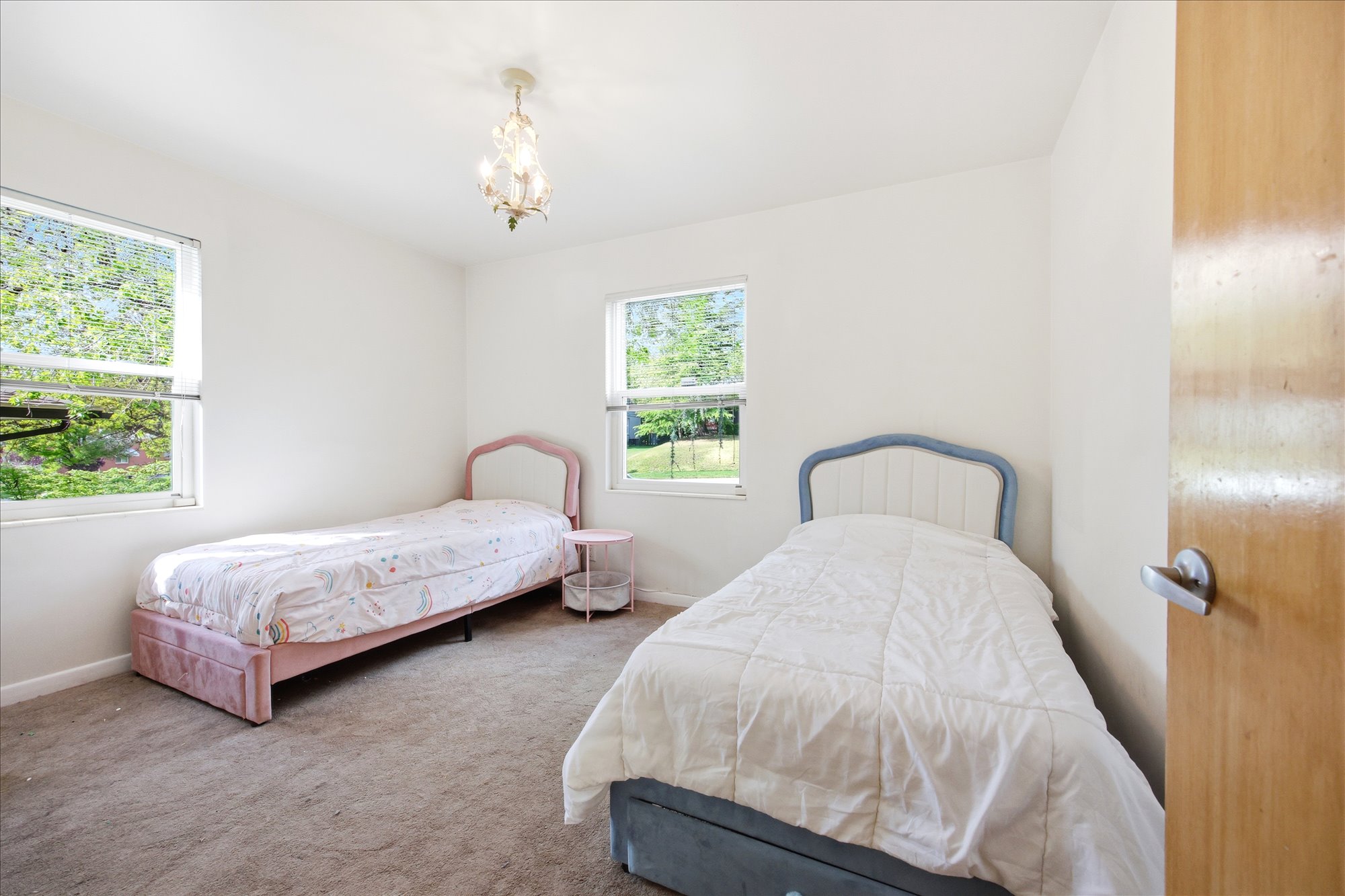Bedroom featuring carpet and a chandelier