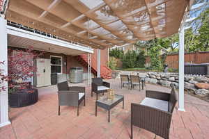 View of patio featuring stairs and outdoor lounge area