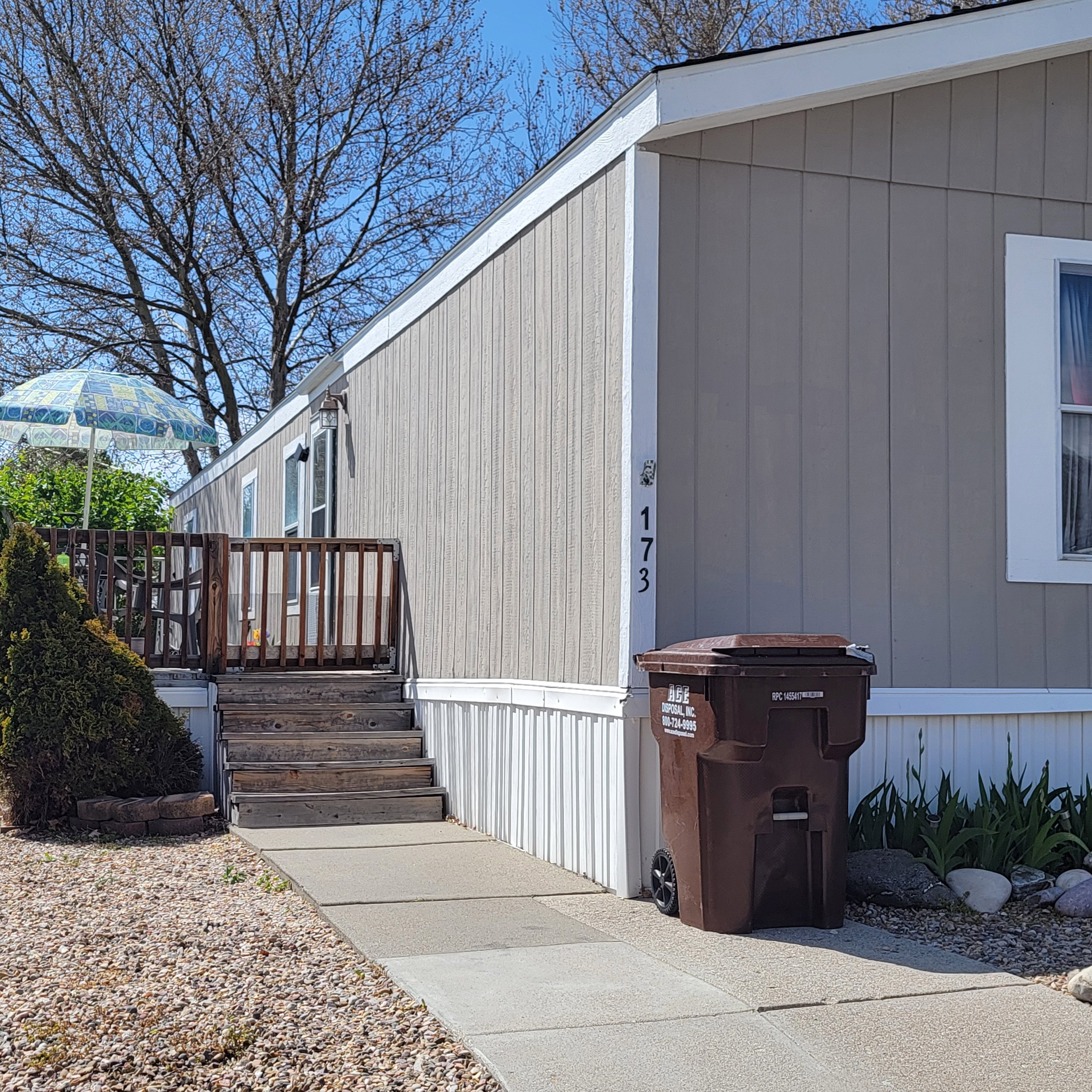 View of side of property featuring a wooden deck