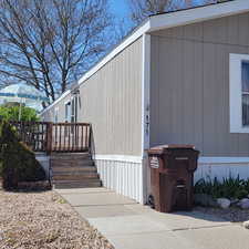 View of side of property featuring a wooden deck