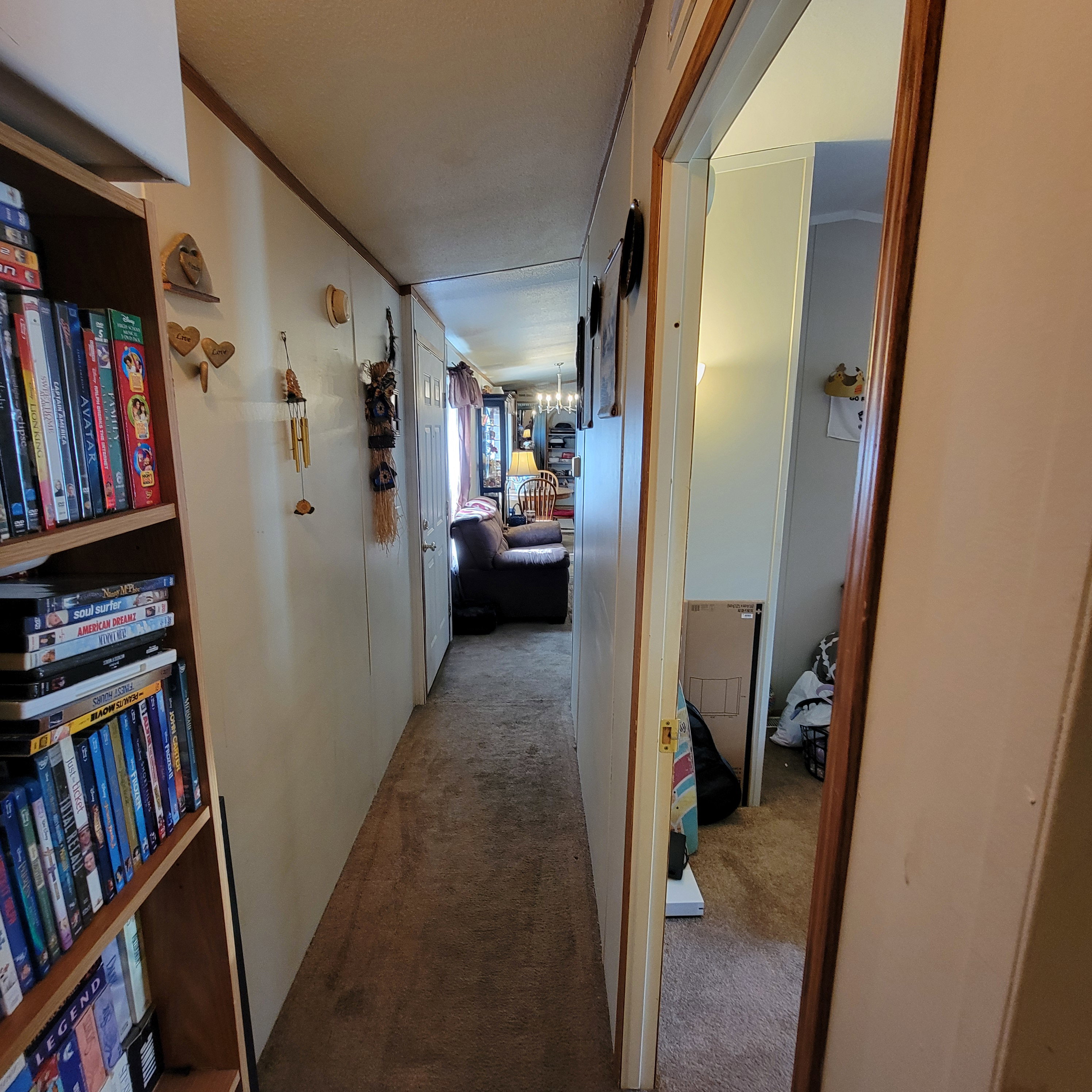 Corridor with light colored carpet and ornamental molding