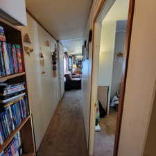 Corridor with light colored carpet and ornamental molding