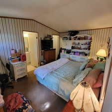 Bedroom with dark colored carpet