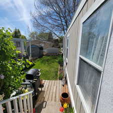 Deck featuring a shed and a grill
