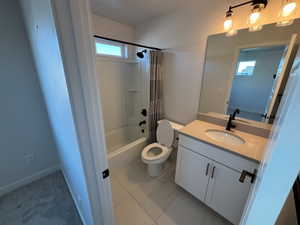 Bathroom with shower / bath combination with curtain and vanity