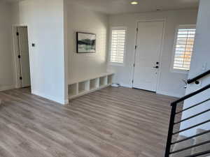 Foyer entrance with light wood-style flooring and recessed lighting