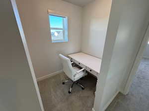 Carpeted home office with baseboards
