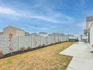 Fenced backyard with a residential view