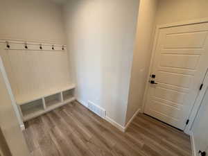 Mudroom featuring light wood-type flooring and baseboards