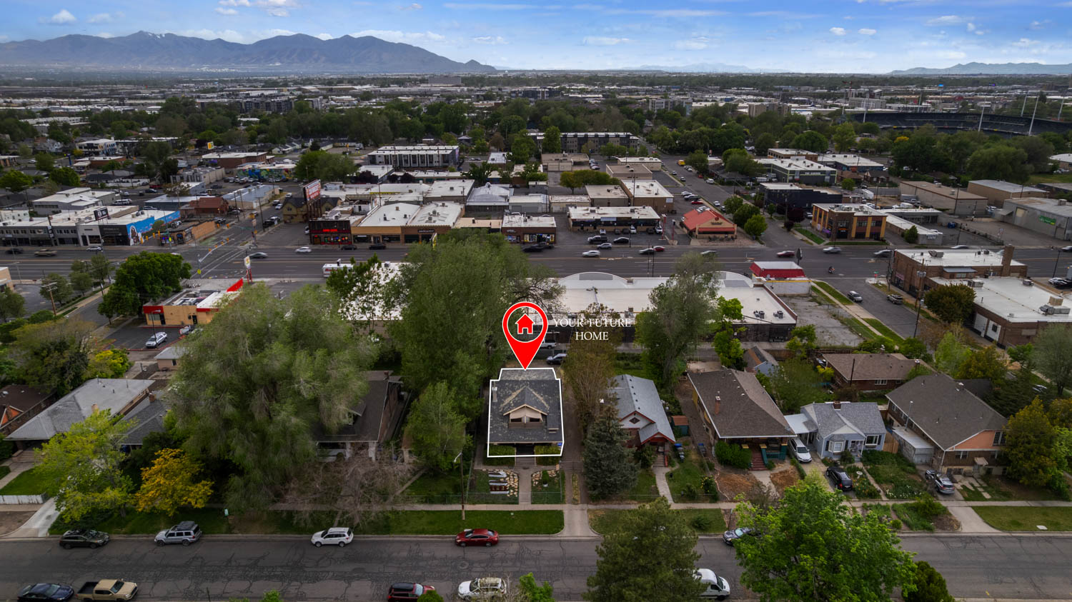 Aerial perspective showcasing a residential property with a gabled roofline and surrounding mature trees