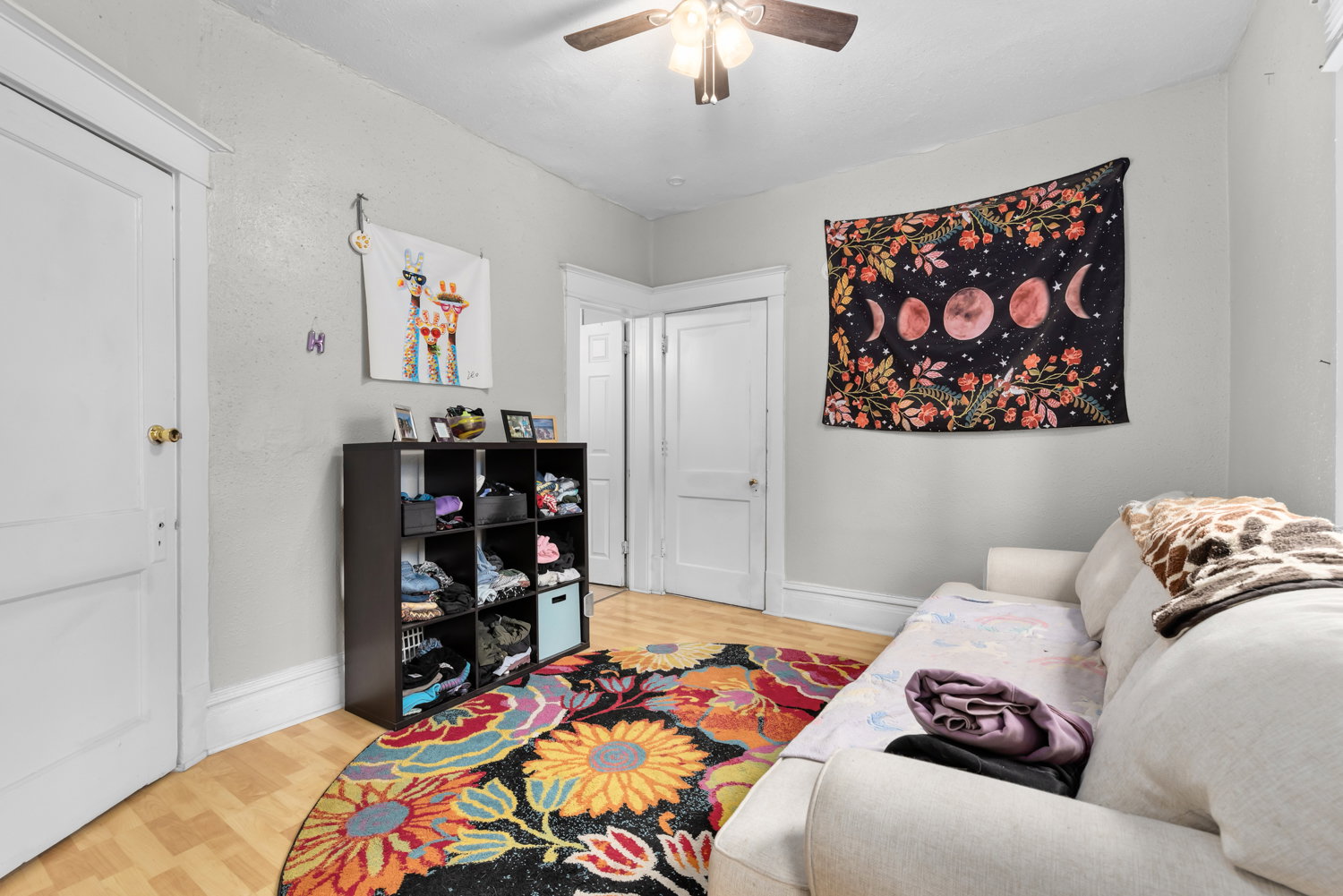 Sitting room with light wood-style flooring and ceiling fan