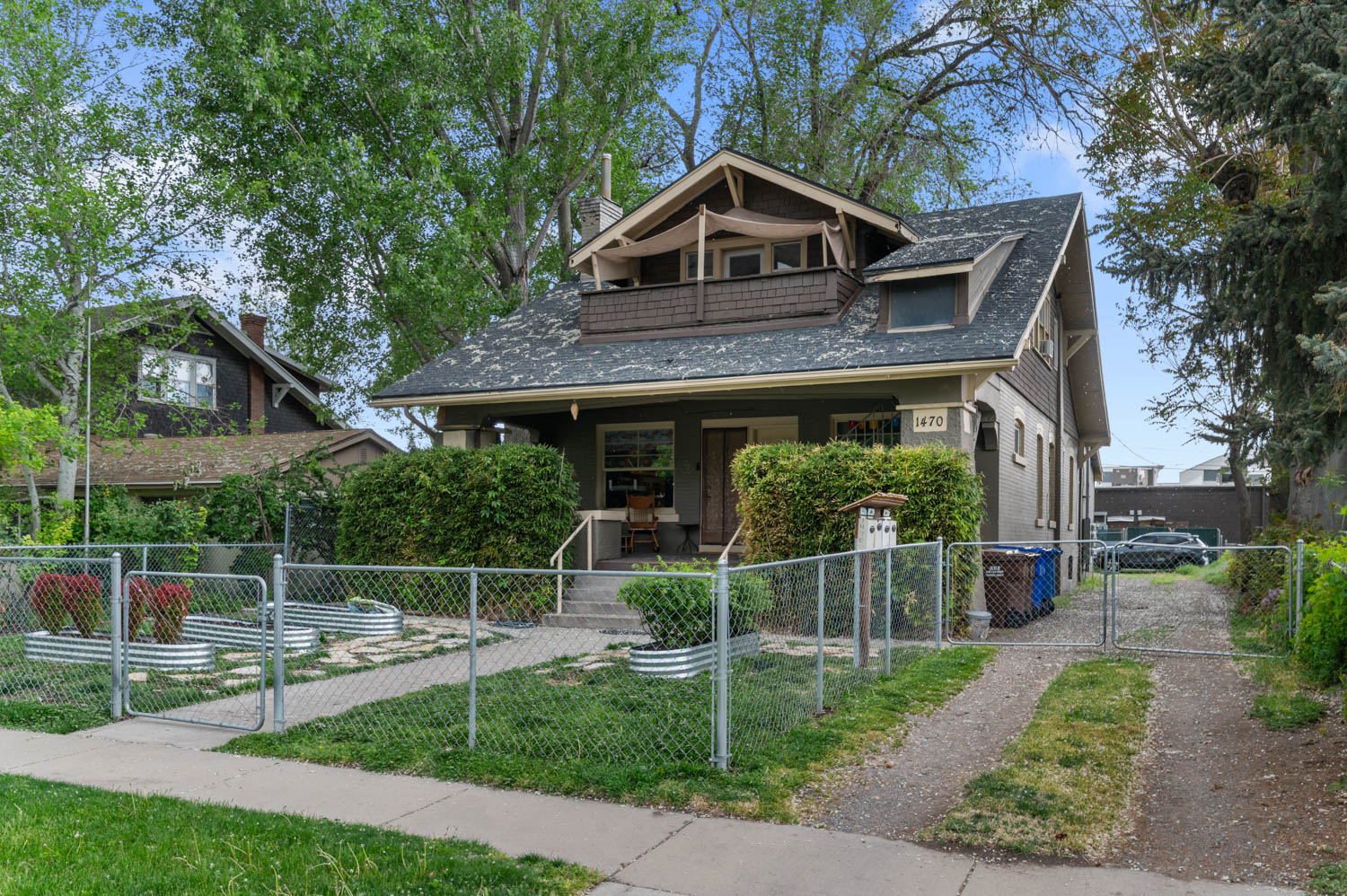 Craftsman-style residence featuring a prominent gabled roof and second-story balcony