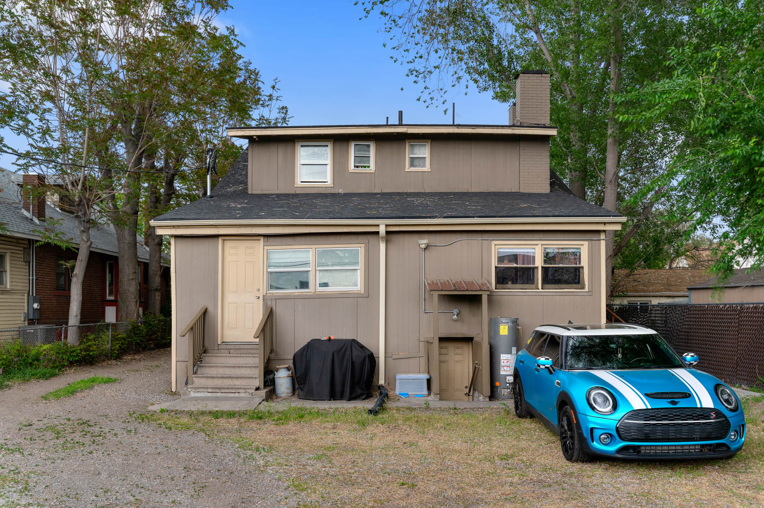 Rear exterior with multi-level design and a shingle roof