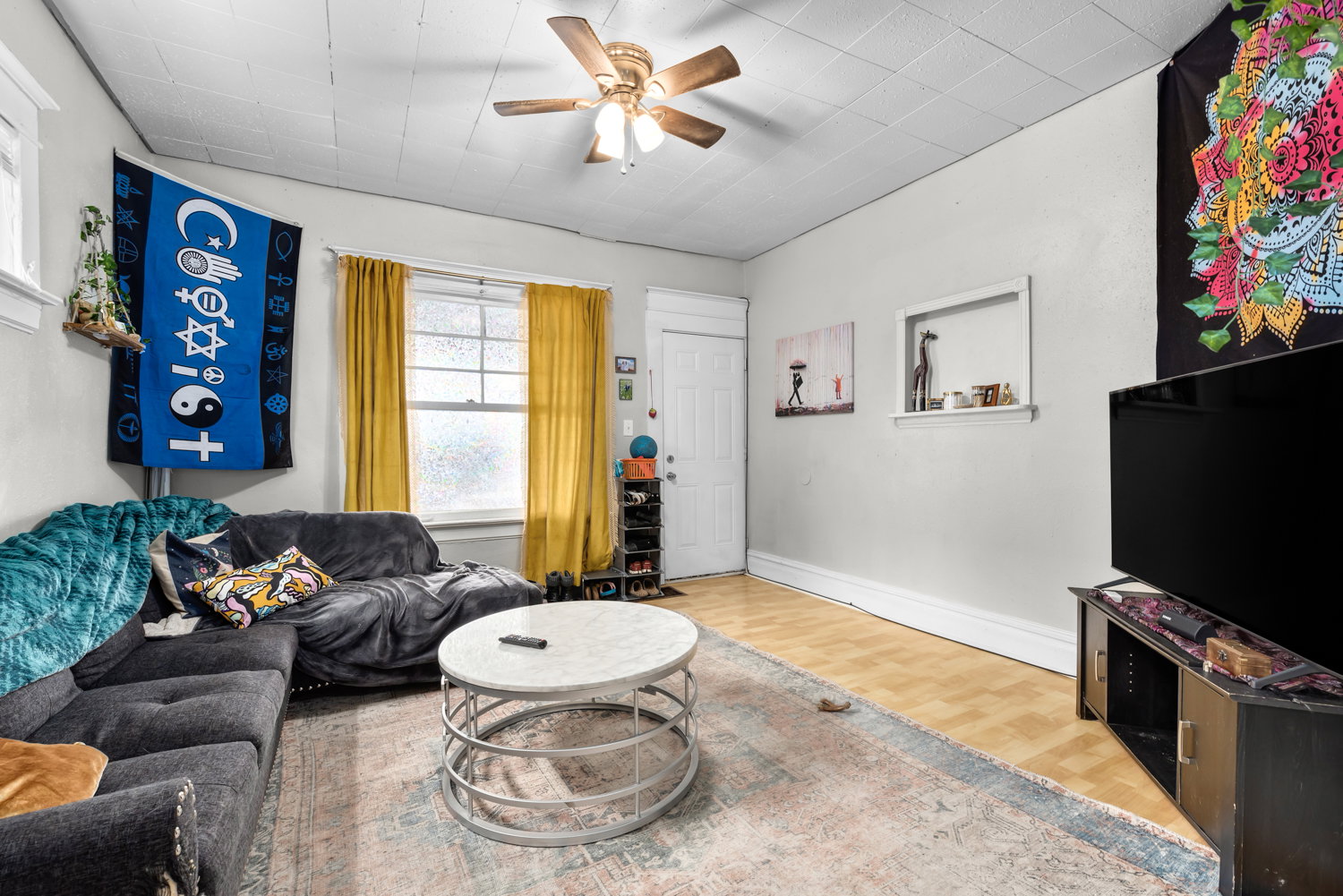 Living area with wood finished floors and a ceiling fan