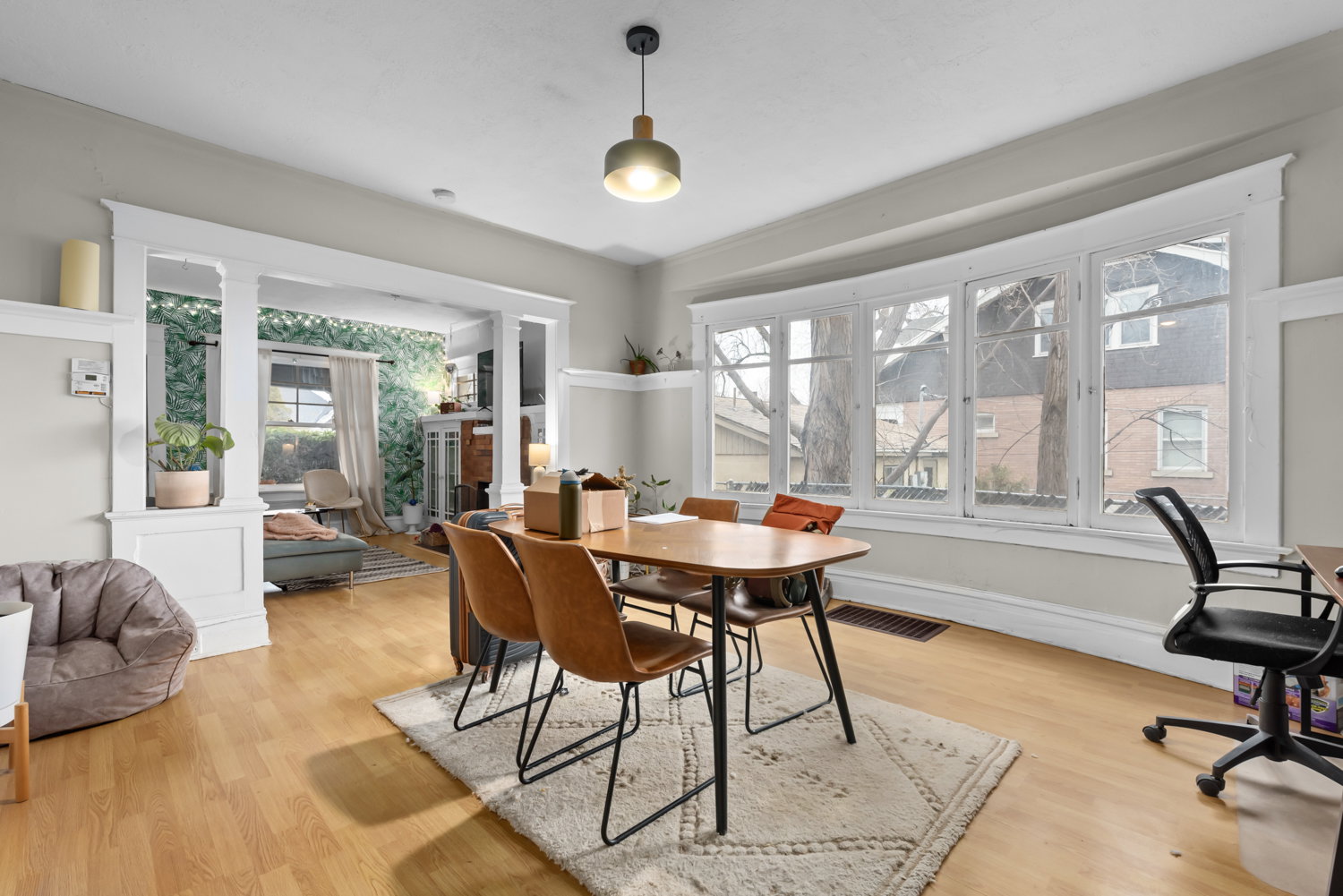 Dining area with light wood-style floors and a fireplace