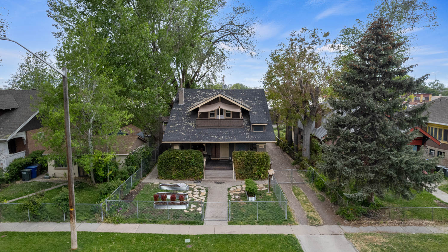 Traditional-style home featuring a covered front porch and an upper-level balcony